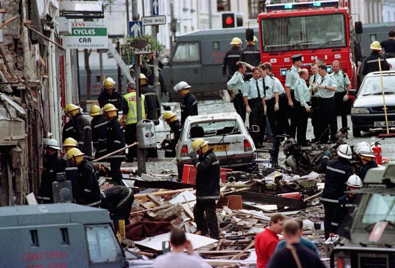 Royal Ulster Constabulary police officers and firefighters inspect the damage caused by a bomb explosion in Market Street, Omagh,  Co Tyrone, Northern Ireland, 72 miles west of Belfast. PA PHOTO PAUL MCERLANE   (Photo by Paul McErlane - PA Images/PA Images via Getty Images)