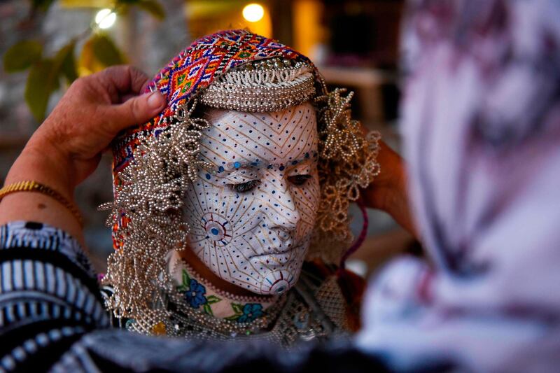 Buqaj stands after receiving a traditional face painting. AFP