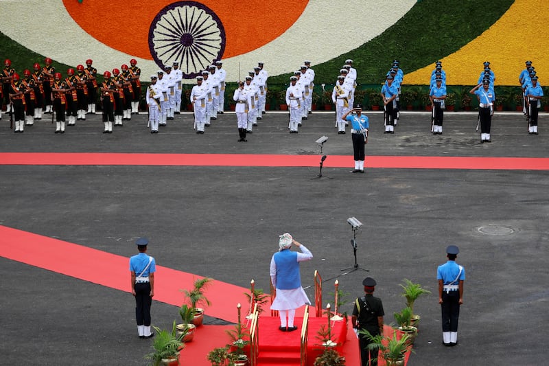 The prime minister salutes the honour guard. Reuters