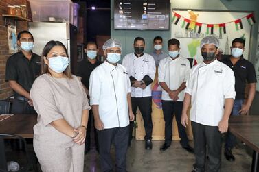 The team from Vasai Local restaurant in Dubai who are one of 18 restaurants providing hundreds of free meals each week as part of the Meals of Grace campaign. Pawan Singh / The National