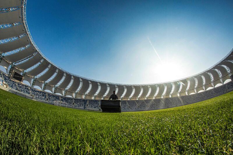 A worker mows the turf.  