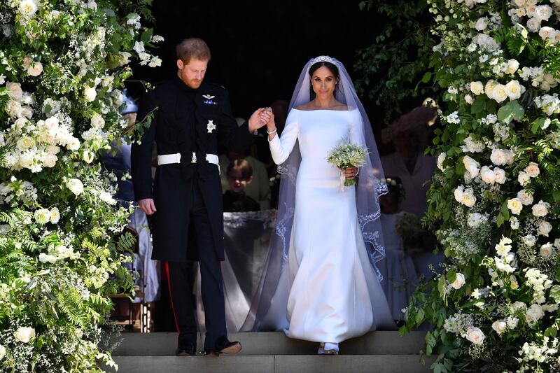 WINDSOR, UNITED KINGDOM - MAY 19: Britain's Prince Harry, Duke of Sussex and his wife Meghan, Duchess of Sussex leave from the West Door of St George's Chapel, Windsor Castle, in Windsor on May 19, 2018 in Windsor, England. (Photo by  Ben STANSALL - WPA Pool/Getty Images)