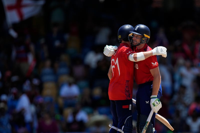 England captain Jos Buttler, right, and batting partner Phil Salt, who made 25, celebrate after their win. AP 