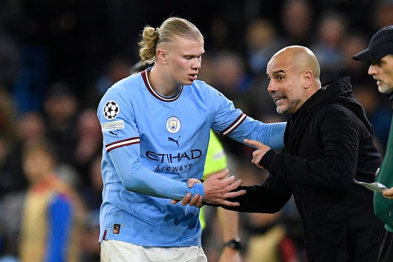 Manchester City' manager Pep Guardiola speaks with striker Erling Haaland during the Champions League tie against Bayern Munich at Etihad Stadium. AFP