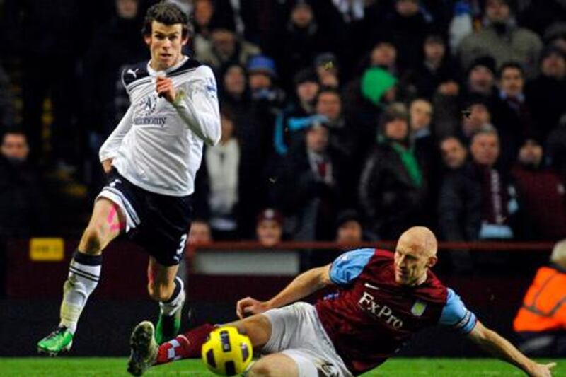Tottenham Hotspurs' Gareth Bale (L) evades the challenge of Aston Villa's James Collins (R) during their English Premier League soccer match at Villa Park in Birmingham December 26, 2010. REUTERS/Toby Melville (BRITAIN - Tags: SPORT SOCCER) NO ONLINE/INTERNET USAGE WITHOUT A LICENCE FROM THE FOOTBALL DATA CO LTD. FOR LICENCE ENQUIRIES PLEASE TELEPHONE ++44 (0) 207 864 9000