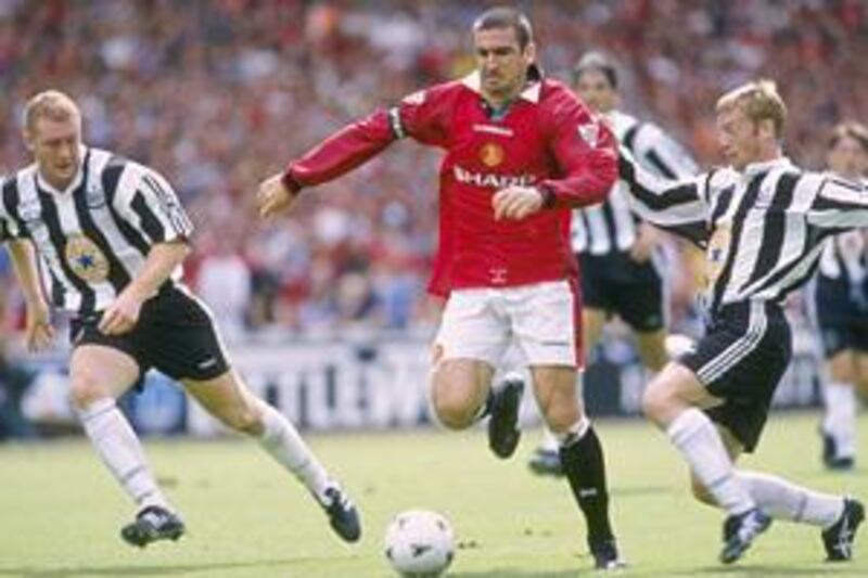 Manchester United's Eric Cantona, centre, holds off a challenge from Newcastle's David Batty, right, in the 1996 Charity Shield.