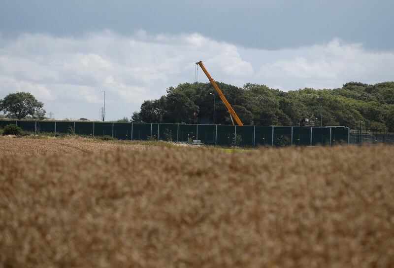 FILE PHOTO: A crane opertates behind barriers at Cuadrilla's Preston New Road fracking site near Blackpool, Britain, 31 July, 2017. REUTERS/Andrew Yates/File Photo