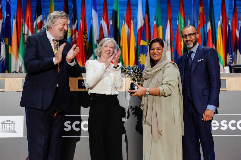 Pakistani teacher Riffat Arif, also known as Sister Zeph receives her award at a ceremony in Paris attended by British celebrity Stephen Fry, left, and Dino Varkey, group chief executive of Gems Education. AFP
