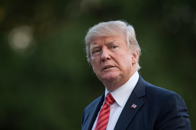 President Donald Trump walks from Marine One across the South Lawn of the White House in Washington, Wednesday, Aug. 23, 2017, as he returns from Reno, Nev. (AP Photo/Carolyn Kaster)