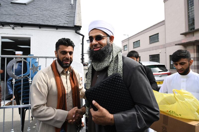 Aihtsham Rashid greets Iman Mufti Abdur Rahman Mangera at the opening of the first mosque built on the Western Isles, Stornoway, Scotland, on May 11, 2018. Jeff J Mitchell / Getty Images