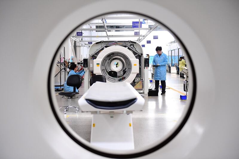 Employees work to assemble computed tomography (CT) scanners  in Liaoning, Shenyang province, China. Stringer / Reuters