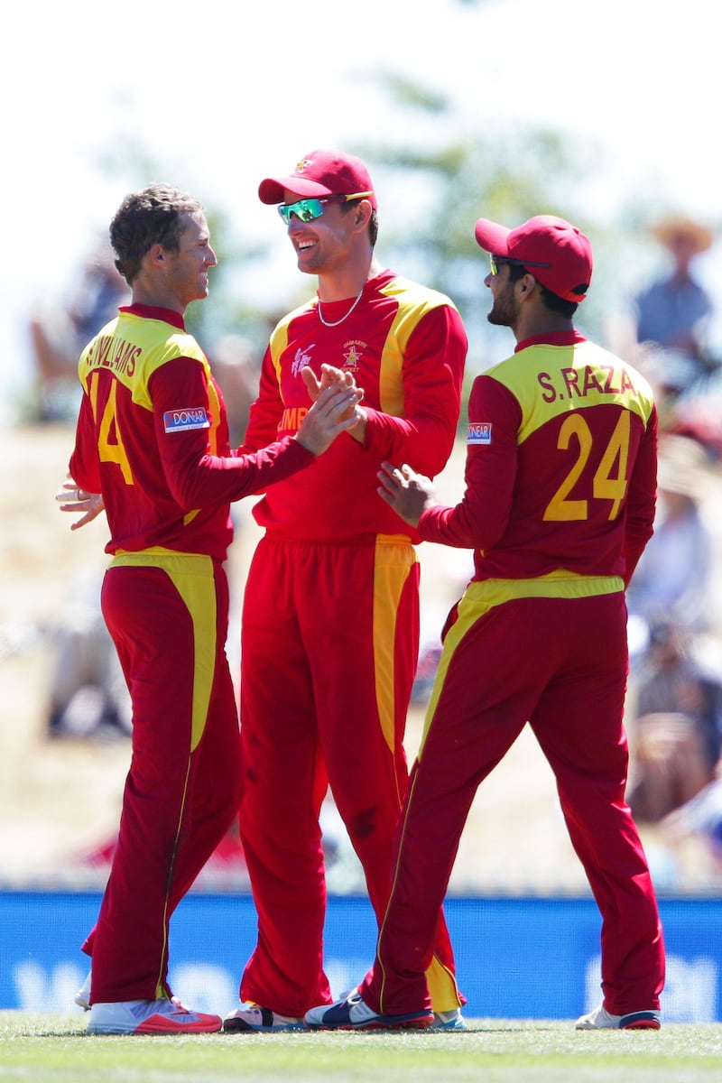 NELSON, NEW ZEALAND - FEBRUARY 19:  L to R, Sean Williams, Craig Ervine and Sikandar Raza of Zimbabwe celebrate the wicket of Shaiman Anwar of the United Arab Emirates during the 2015 ICC Cricket World Cup match between Zimbabwe and the United Arab Emirates at Saxton Field on February 19, 2015 in Nelson, New Zealand.  (Photo by Hagen Hopkins/Getty Images)