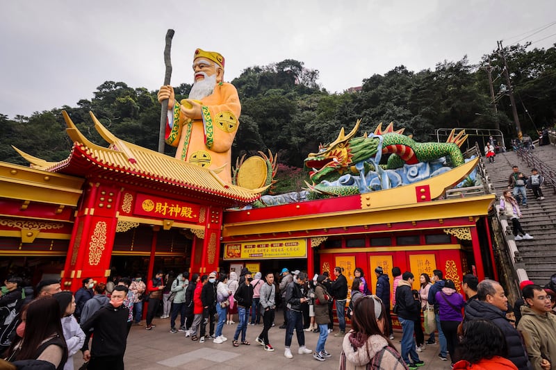 People queue to pray at a temple during the celebration of the Chinese Lunar New Year in Taipei, Taiwan. EPA