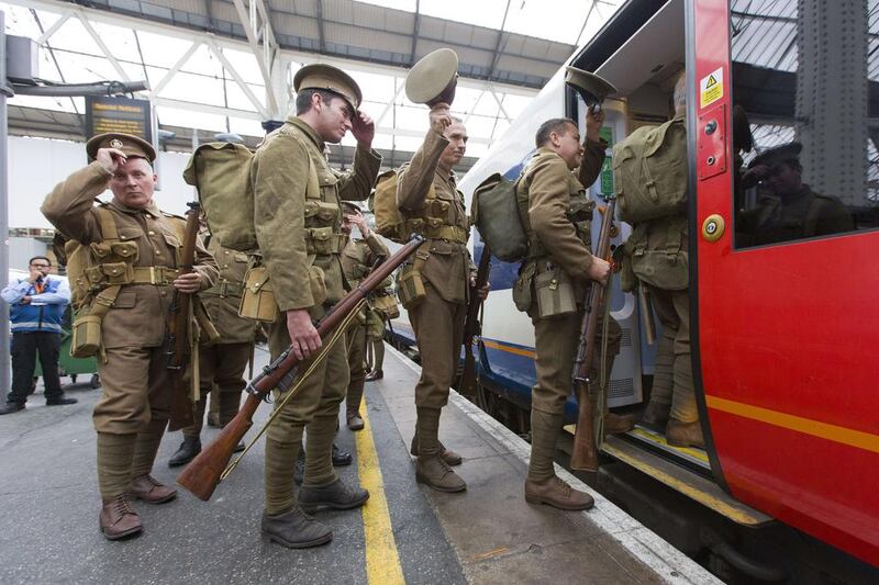 Members of the Association of Military Remembrance, also known as The Khaki Chums, wave goodbye as they board the train as they re-enact the journey 100 years ago today of the first WW1 soldiers to mobile at London’s railway stations to travel to the south coast before onward deployment to France at Waterloo station in London. Justin Tallis / AFP Photo