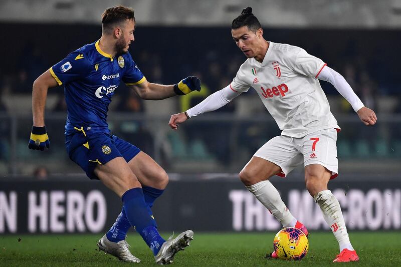 Juventus forward Cristiano Ronaldo battles for the ball with Verona midfielder Miguel Veloso. AFP