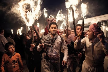 AKRE, IRAQ: Men march with torches during the Newroz festival that marks Kurdish New Year. Photo by Sebastian Meyer