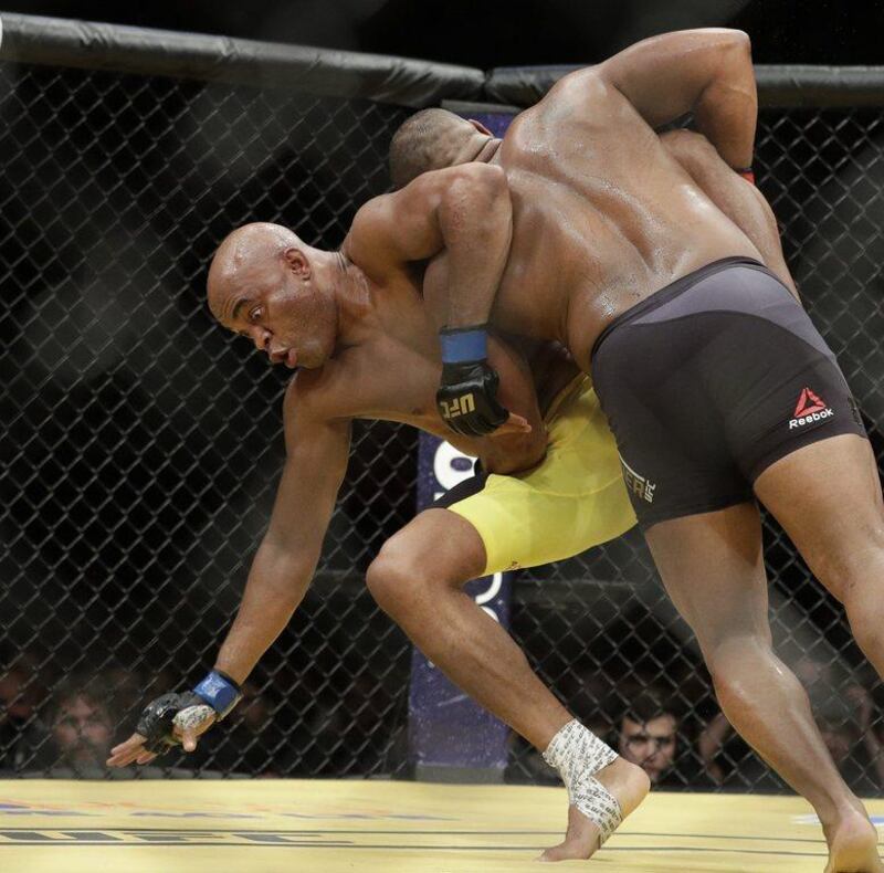 Daniel Cormier, right, takes down Anderson Silva during their light heavyweight bout at UFC 200, Saturday, July 9, 2016, in Las Vegas. John Locher / AP Photo