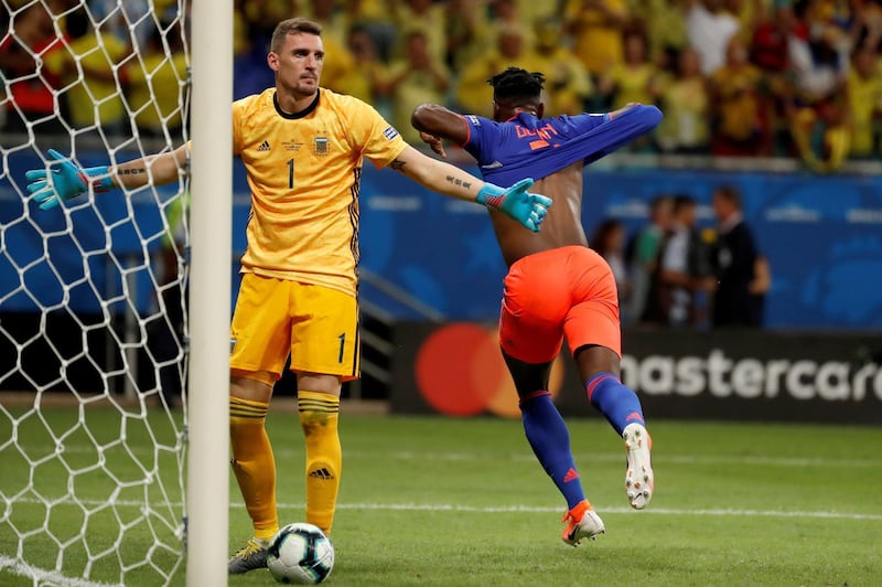 Colombia's Duvan Zapata celebrates after scoring against Argentinian goalkeeper Franco Armani. EPA