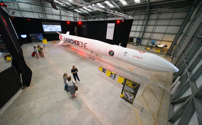 People look at the Virgin Orbit Launcher One rocket on the opening day of the Story of a Satellite summer exhibition at Spaceport Cornwall last August in Newquay, England. Getty Images)