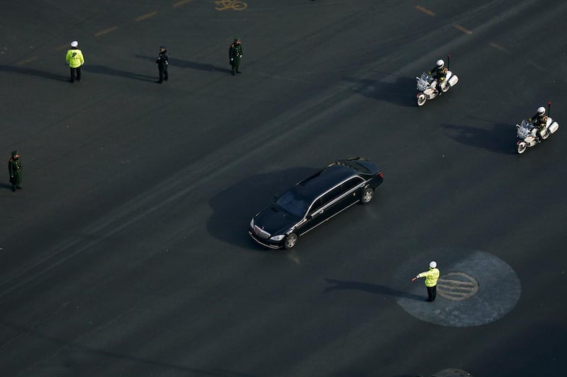A Mercedes limousine with a golden emblem, similar to one Kim Jong-un has used previously, is escorted by motorcades travelling past Chang'an Avenue in Beijing. AP Photo