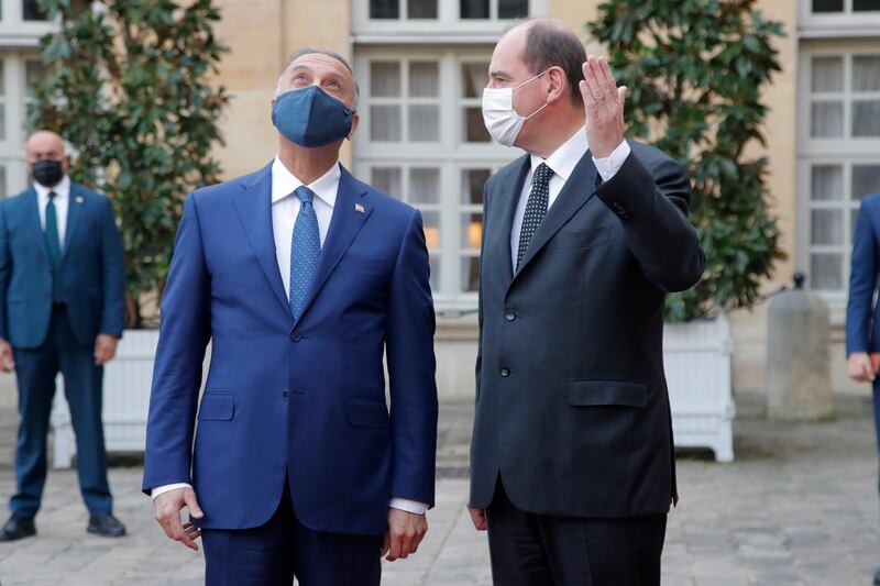 French Prime Minister Jean Castex, right, welcomes Iraqi Prime Minister Mustafa al-Kadhimi before their talks in Paris. AP Photo
