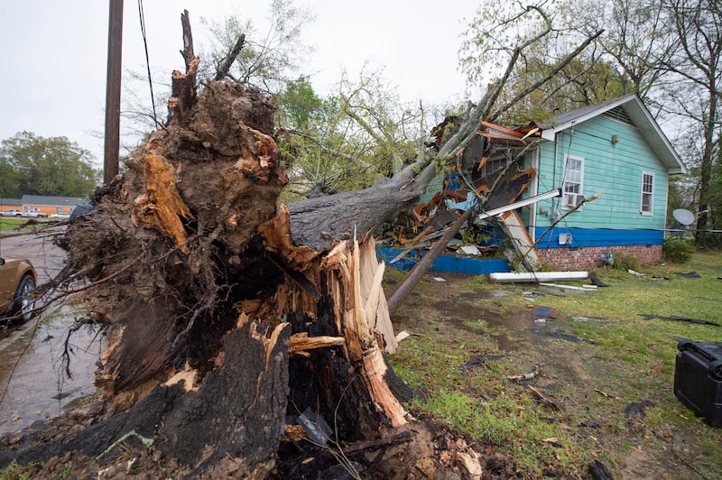 A house on Summer Street in Jackson, Mississippi, was heavily damaged by a downed tree during severe weather that moved through the city on Wednesday, March 30, 2022. The Clarion-Ledger / AP