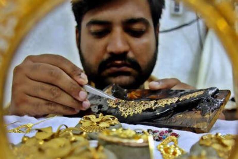 epa02137585 Pakistani Goldsmith make gold ornaments at his shop in Peshawar Pakistan a day ahead of World Labor Day, on 30 April 2010. Various labour organisation throughout Pakistan will take out processions and organise seminars to highlight the problems of the workers on 01 May the International Labour Day.  EPA/ARSHAD ARBAB