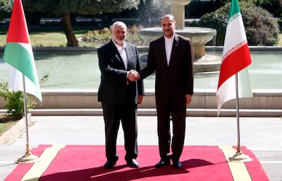 Iranian Foreign Minister Hossein Amirabdollahian, right, meets Hamas leader Ismail Haniyeh in Tehran. EPA 