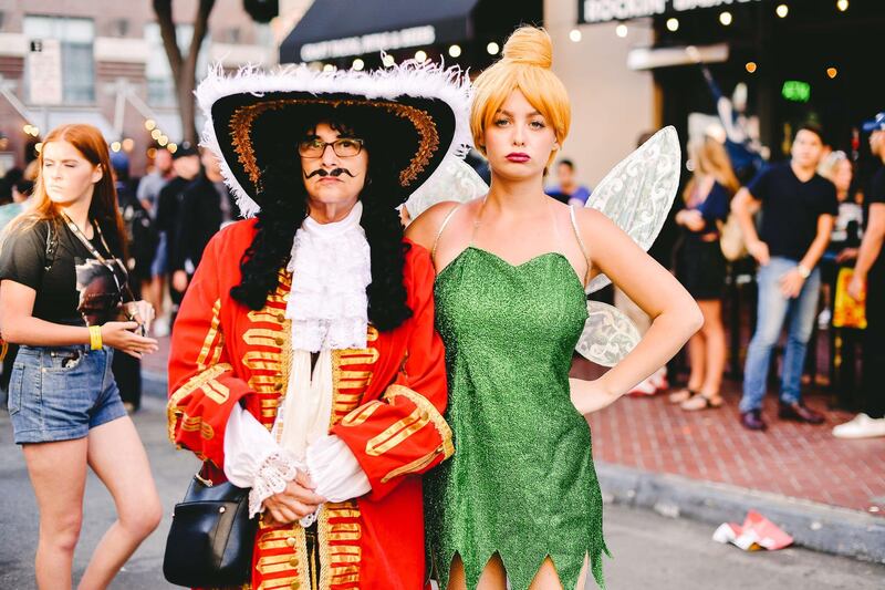 Cosplayers are dressed as Hook and Tinkerbell. AFP