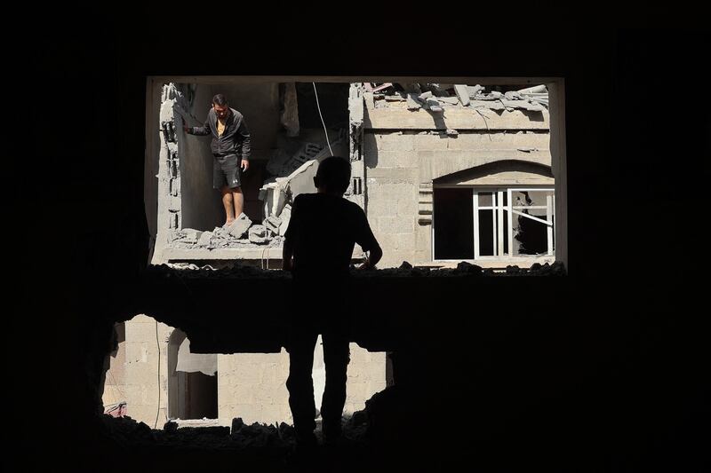 Palestinians inspect the damage around the Derby family house struck during Israeli bombardment of Rafah's Tal Al Sultan district, in Gaza. AFP