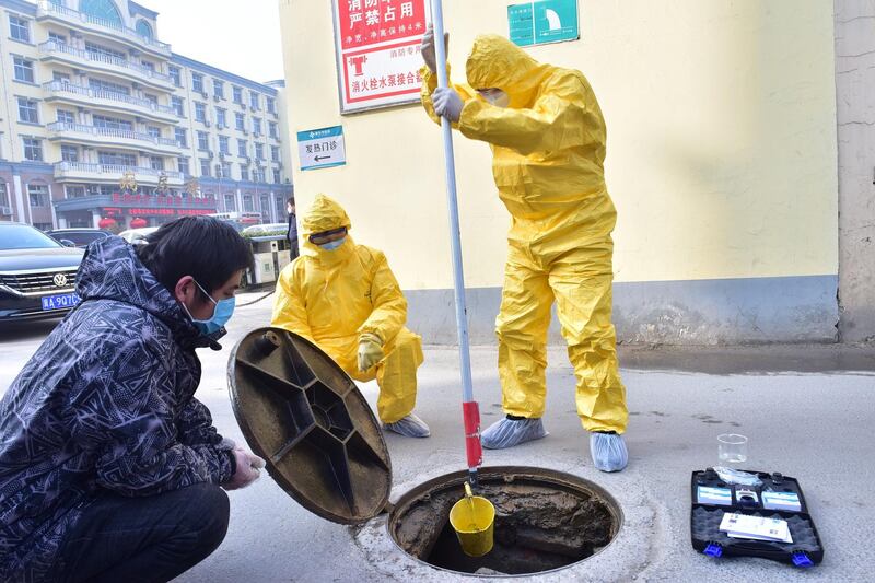 Workers of the ecology and environment bureau collect samples from the sewage system of a hospital following an outbreak of the novel coronavirus in the country, in Xinle, Hebei province, China. REUTERS