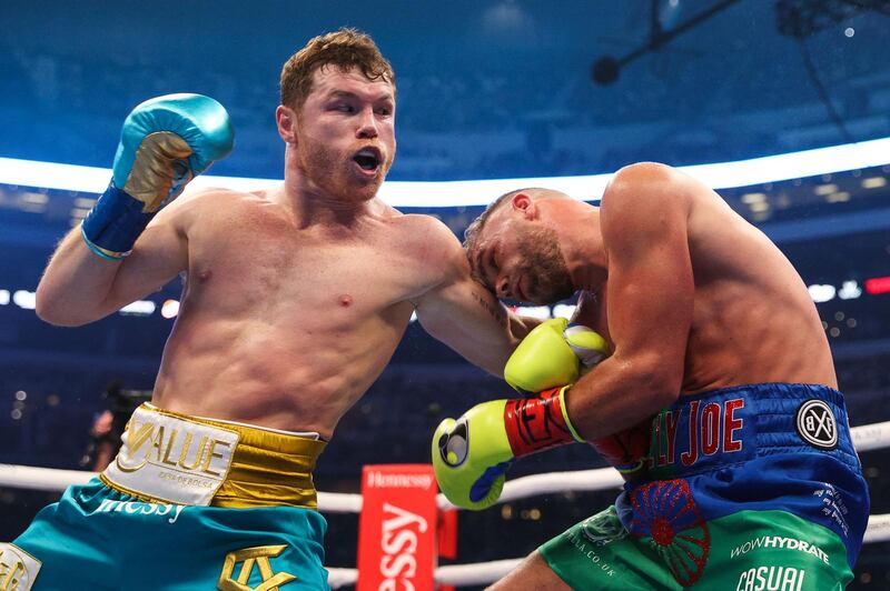 Saul Alvarez lands a body shot on Billy Joe Saunders during their super middleweight title fight at the AT&T Stadium. AFP