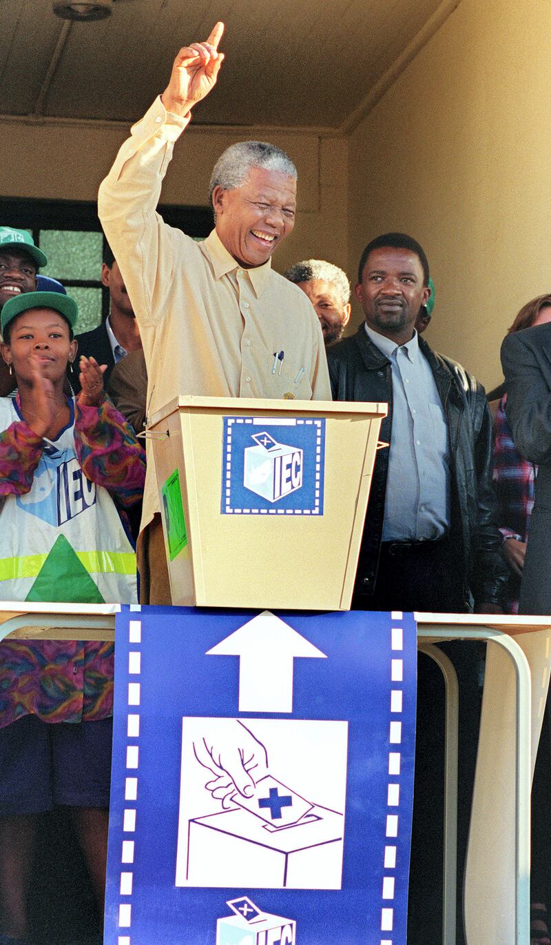 African National Congress (ANC) President Nelson Mandela smiles broadly 27 April 1994 in Oshlange, black township near Durban, as he casts his historic vote during South Africa's first democratic and all-race general elections.