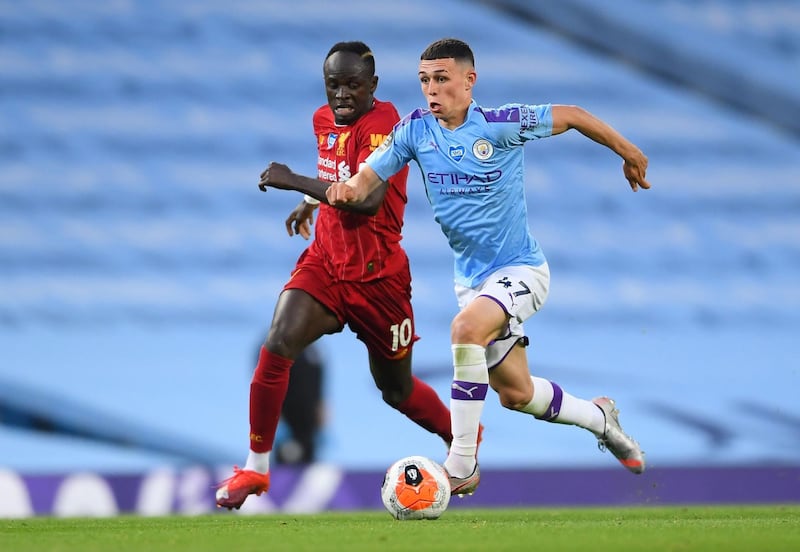 Manchester City's Phil Foden in action with Liverpool's Sadio Mane. Reuters