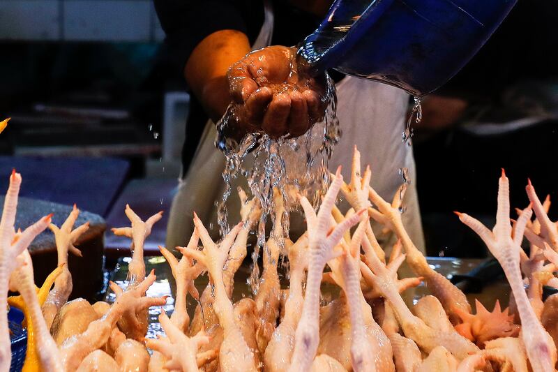 A worker prepares chickens at wet market in Kuala Lumpur, Malaysia. Malaysia will stop the export of 3. 6 million whole chickens a month until production and prices stabilise, Prime Minister Ismail Sabri Yaakob has said. EPA 