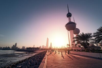 View of Kuwait Towers with Kuwait City in the background at sunset.