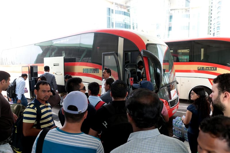 Passengers wait to board a bus bound for Dubai at the main bus terminal in Abu Dhabi on the last weekend of Ramadan. Christopher Pike / The National

