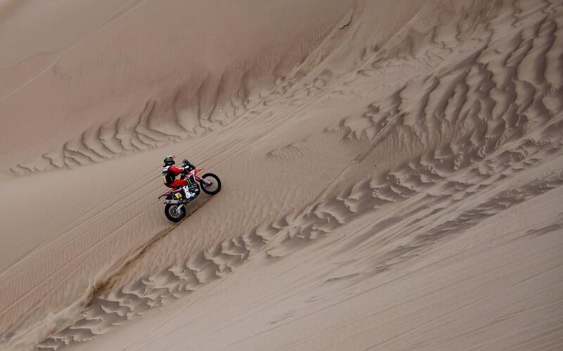 Honda's Portuguese biker Paulo Goncalvez rides up a dune. AFP
