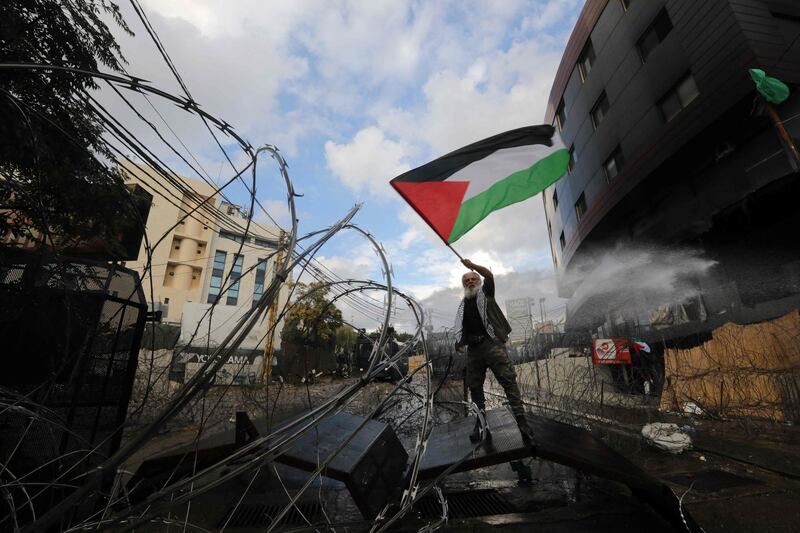 Many that took place in the protest waved Palestinian flags outside the US embassy. AFP