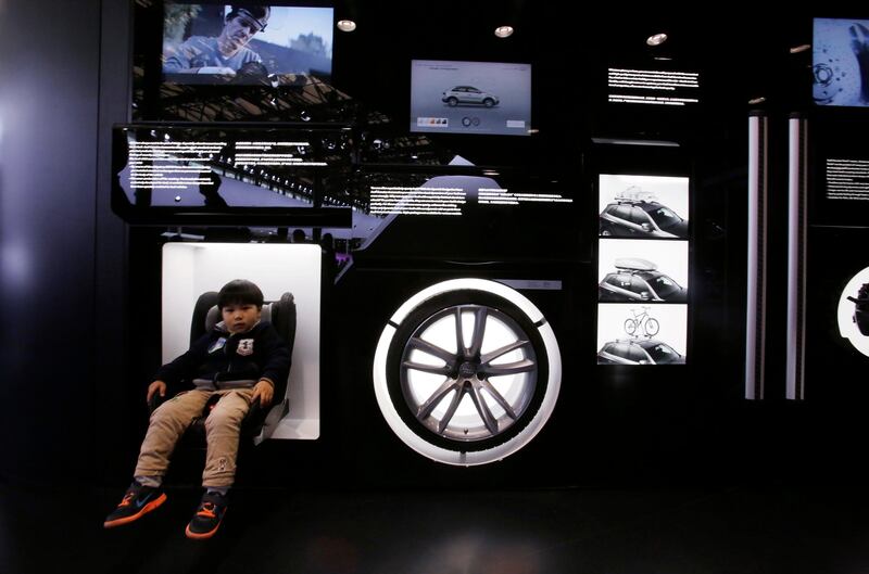 A young visitor tries out a child seat at the Audi booth at the Shanghai International Automobile Industry Exhibition (AUTO Shanghai) in Shanghai, China Sunday, April 21, 2013. (AP Photo/Eugene Hoshiko) *** Local Caption ***  China Auto Show.JPEG-0fd45.jpg