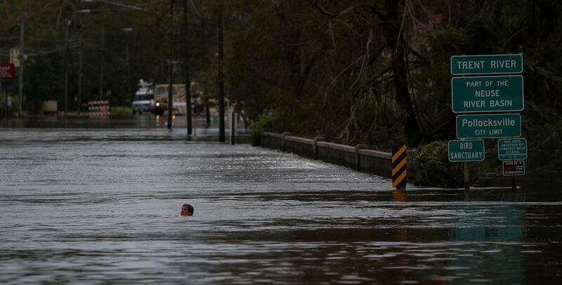 A man swims in a flooded street after the passage of Hurricane Florence in New Bern, North Carolina. Reuters