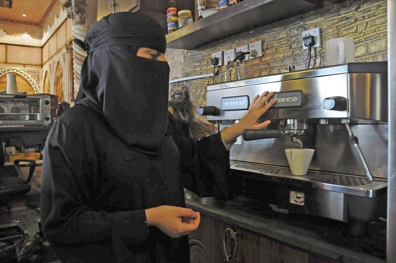 A Saudi woman works at a coffee shop in Tabuk, 1500km from Riyadh. Many Saudi nationals are now cutting their dependence on the state. Mohamed Alhwaity / Reuters



