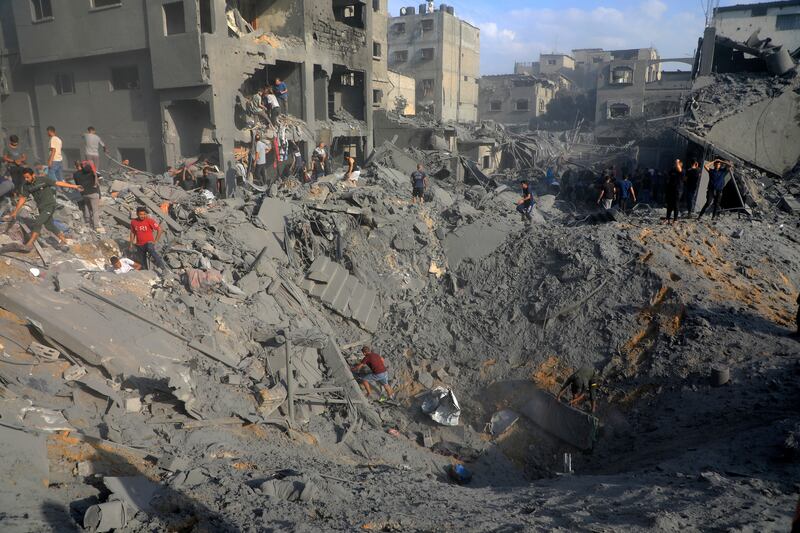 Palestinians look for survivors among the rubble of destroyed buildings following Israeli strikes on Jabalia refugee camp in northern Gaza. AP