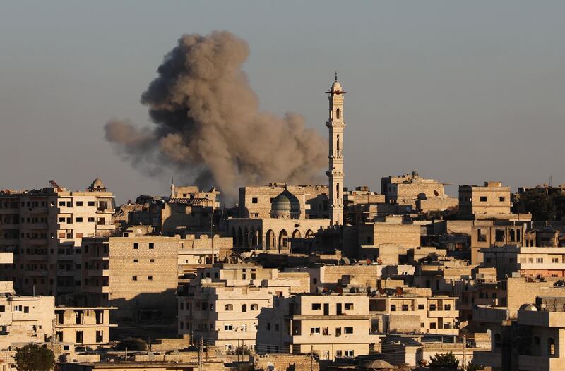 Smoke billows above building during recent air strikes by pro-regime forces in the jihadist-held city of Maaret al-Numan in Syria's northwestern Idlib province, on January 25, 2020. Regime forces, backed by Russian warplanes, have increased their attacks on southern Idlib since December, displacing more than 358,000 people, according to the United Nations.
Maaret al-Numan is one of the largest urban centres in Syria's last major opposition bastion and a key target of the regime, the monitor said.
 / AFP / Omar HAJ KADOUR
