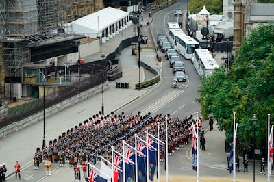 A fleet of buses alongside US President Joe Biden's motorcade on the approach to Westminster Abbey. AP 