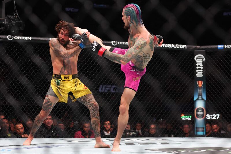 Sean O'Malley, right, head kicks Marlon Vera on his way to a unanimous victory to defend his UFC bantamweight belt. Getty