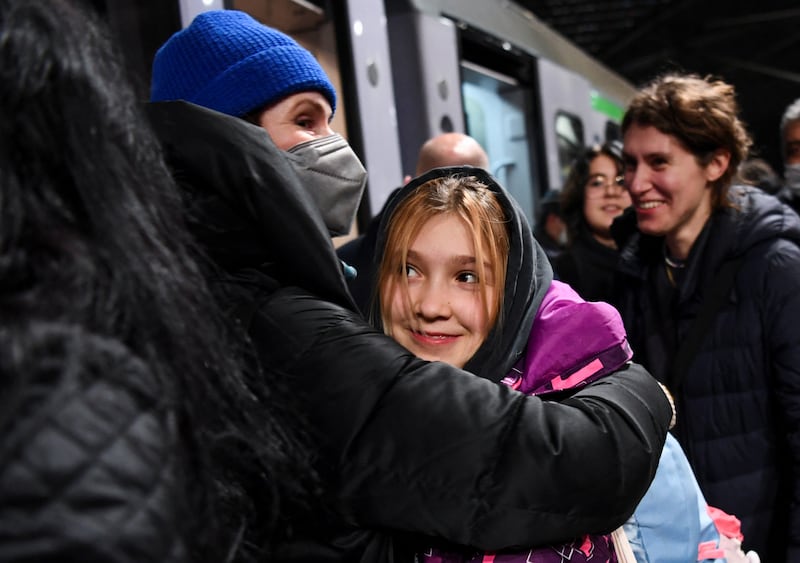 A woman welcomes a child who has arrived in Berlin on a train from Poland. Reuters