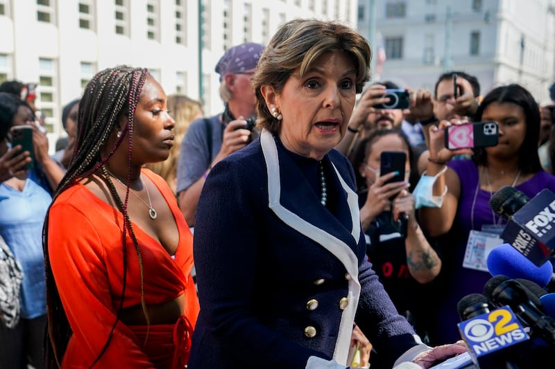 Lawyer Gloria Allred speaks alongside Ms Cunningham outside the federal court. AP