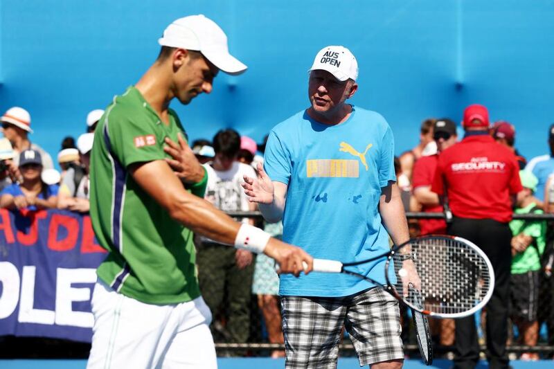 Novak Djokovic of Serbia and his coach Boris Becker take part in a practice session. Matt King / Getty Images