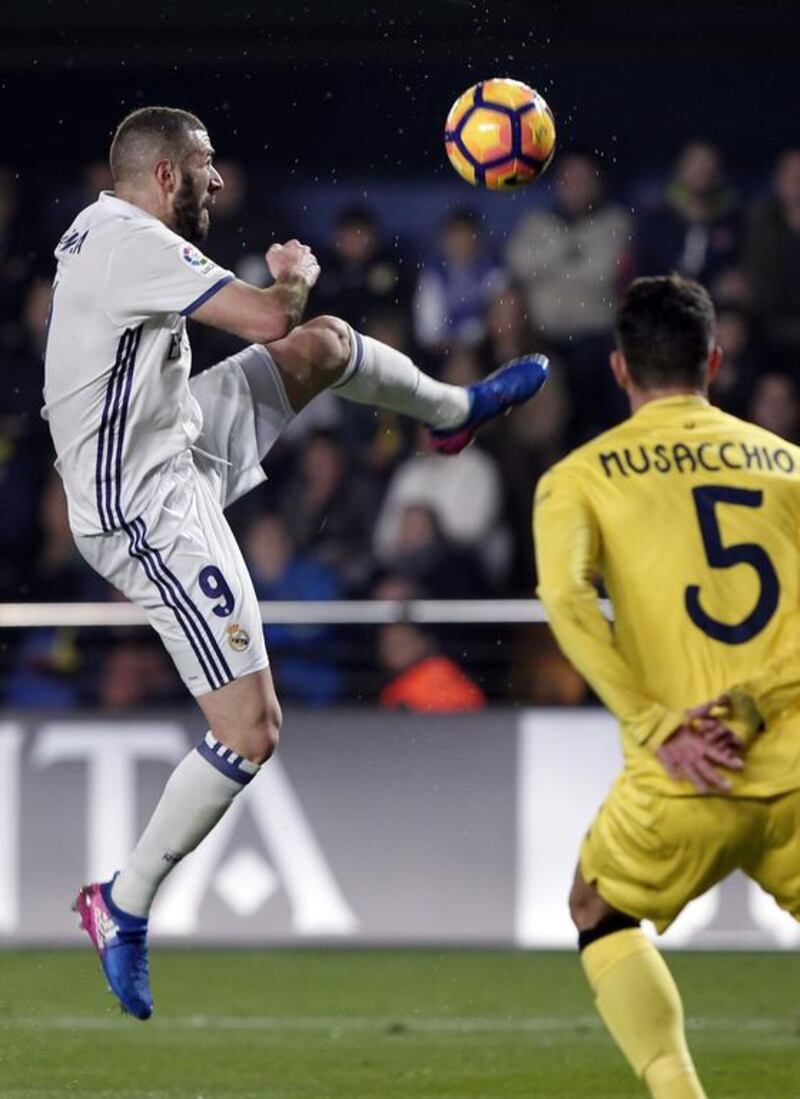 Real Madrid’s Karim Benzema, left, controls the ball in front of Villarreal’s Mateo Musacchio. Jose Miguel Fernandez / AP Photo